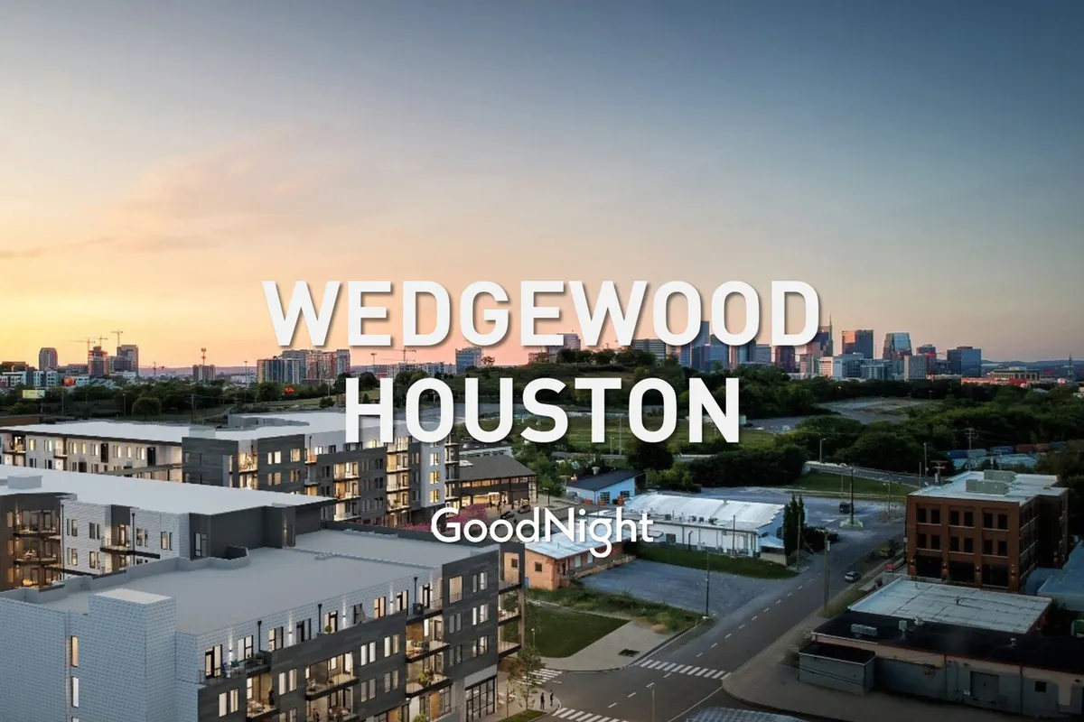 This image features modern apartment buildings set against the Nashville city skyline at sunset, with a serene and hopeful mood. The scene suggests urban living and a vibrant neighborhood, ideal for evening strolls, communal experiences, and enjoying local amenities.
