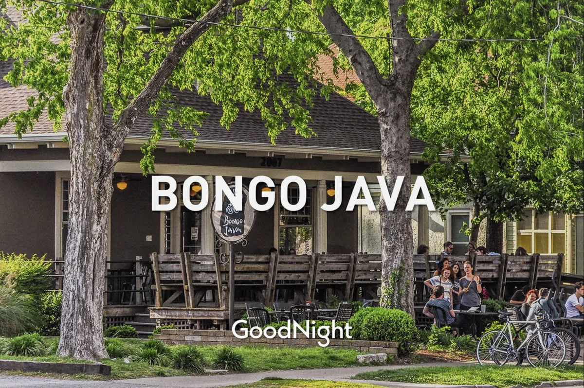A vibrant local café scene featuring the Bongo Java sign, outdoor tables, socializing people, and bicycles. The bright, welcoming atmosphere highlights the walkable neighborhood and opportunities for informal gatherings just steps away from the townhomes.